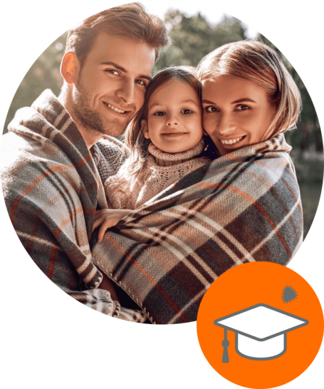 Smiling family of three wrapped in a plaid blanket outdoors, with an orange icon featuring a graduation cap in the corner.